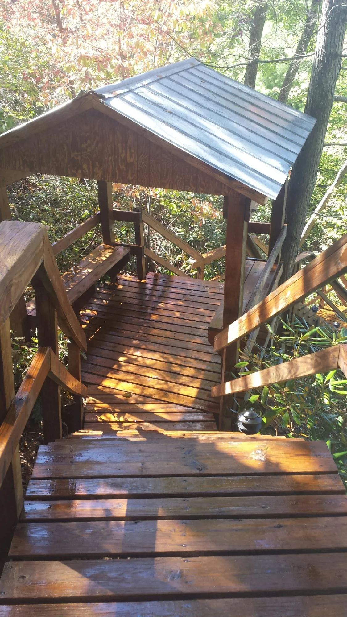 Freshly stained wood walkway and covered shelter with a metal roof in Aransas Pass