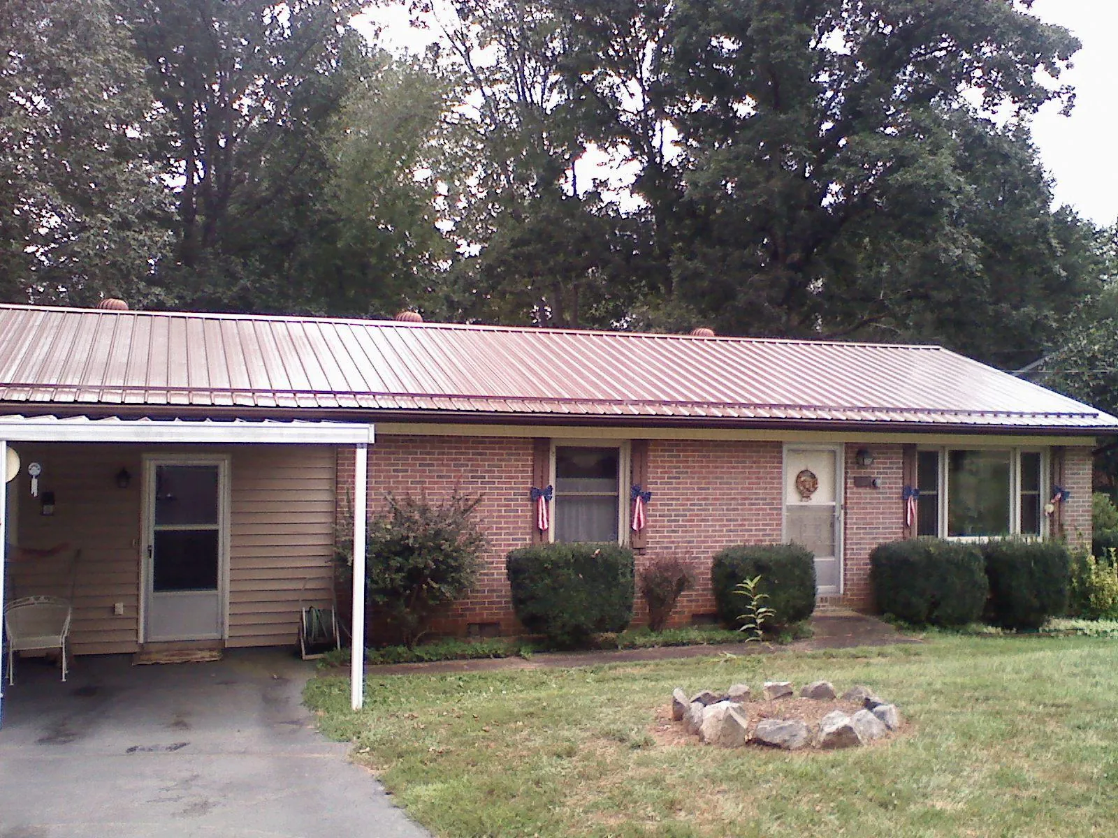 Bronze metal roof and carport on a brick ranch home — Roof Repair work by our crew in Aransas Pass